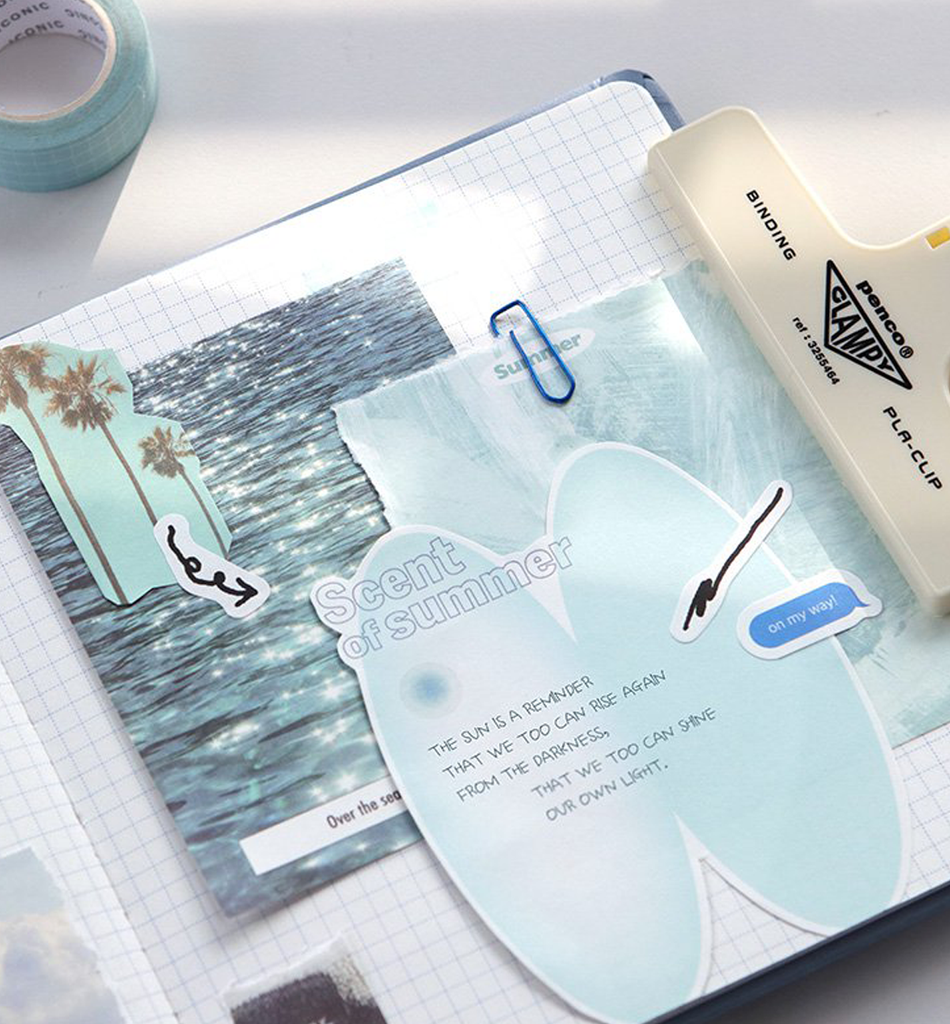 The Journal Shop - Blue Iconic Deco Memo Pad with seaside and sky motifs displayed beside stationery items.