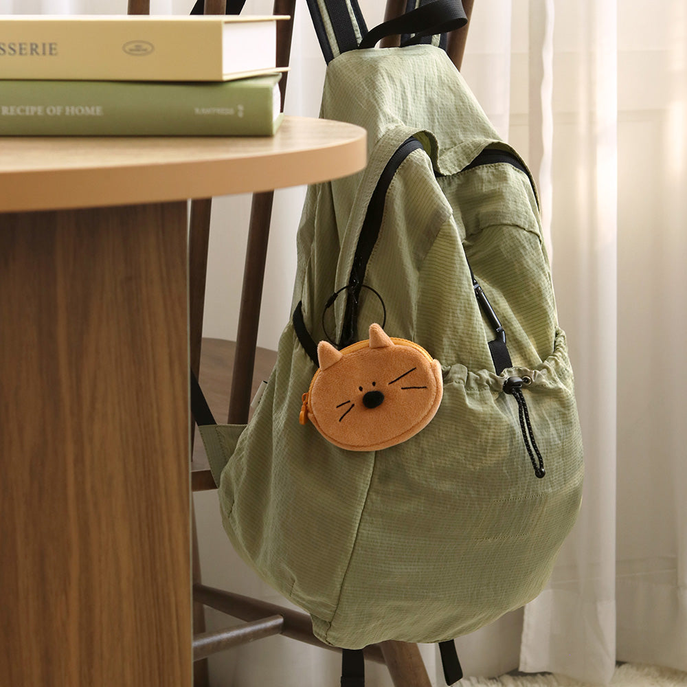 The Journal Shop - Brown bear Doodle Compact Keyring Pouch attached to a khaki backpack strap.
