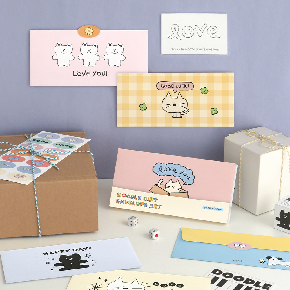 The Journal Shop - Collection of Iconic Doodle Envelopes and stickers featuring cute illustrated characters displayed beside wrapped gift boxes.