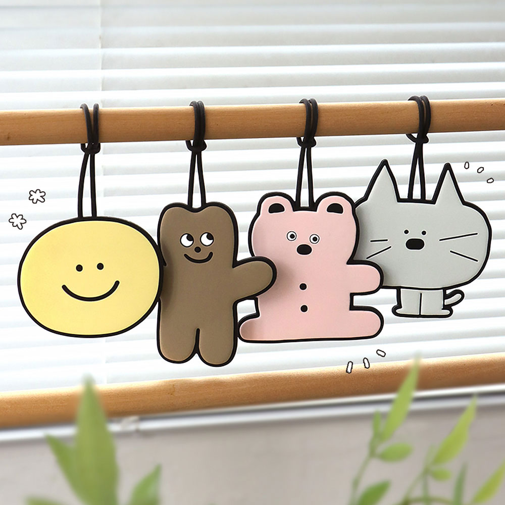 The Journal Shop - Set of Iconic Doodle Luggage Tags in fun character shapes hanging from a wooden rail by their straps.
