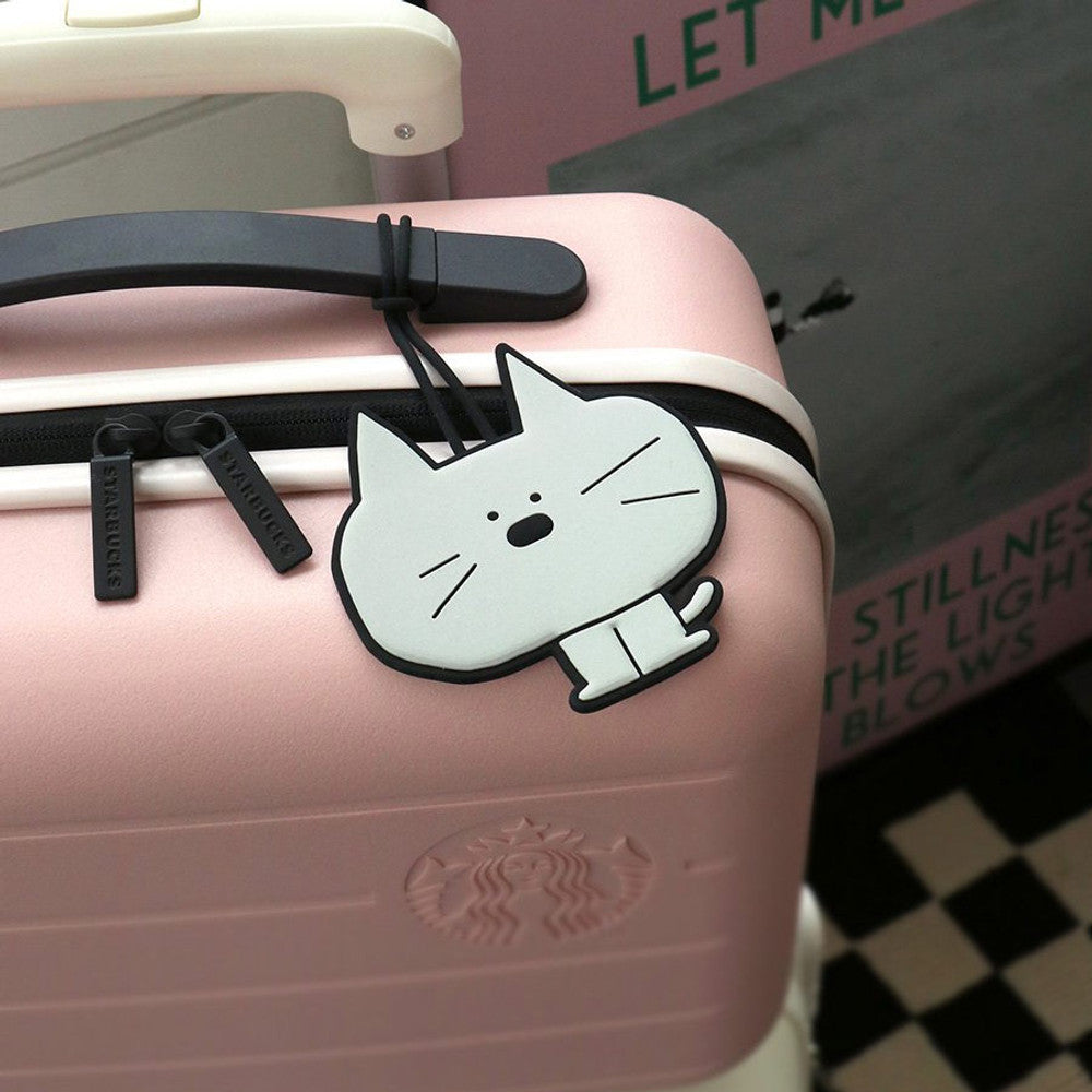 The Journal Shop - Pink suitcase decorated with Iconic Doodle Luggage Tags cat designs.