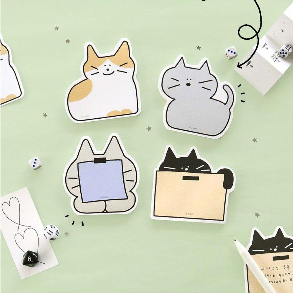 The Journal Shop - Iconic doodle memo pads in playful cat shapes on green desk background
tear-off cat sticky notes in assorted colours and designs
close-up of Iconic doodle memo pad featuring black cat with notepad space
flat lay of Iconic cat memo pads with dice and pen on pastel background.