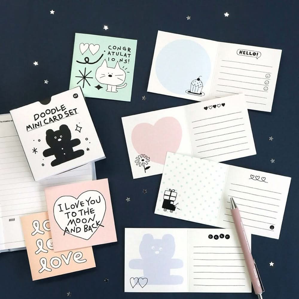 The Journal Shop - Iconic Doodle Mini Cards in various colours with printed doodle messages spread across dark background.