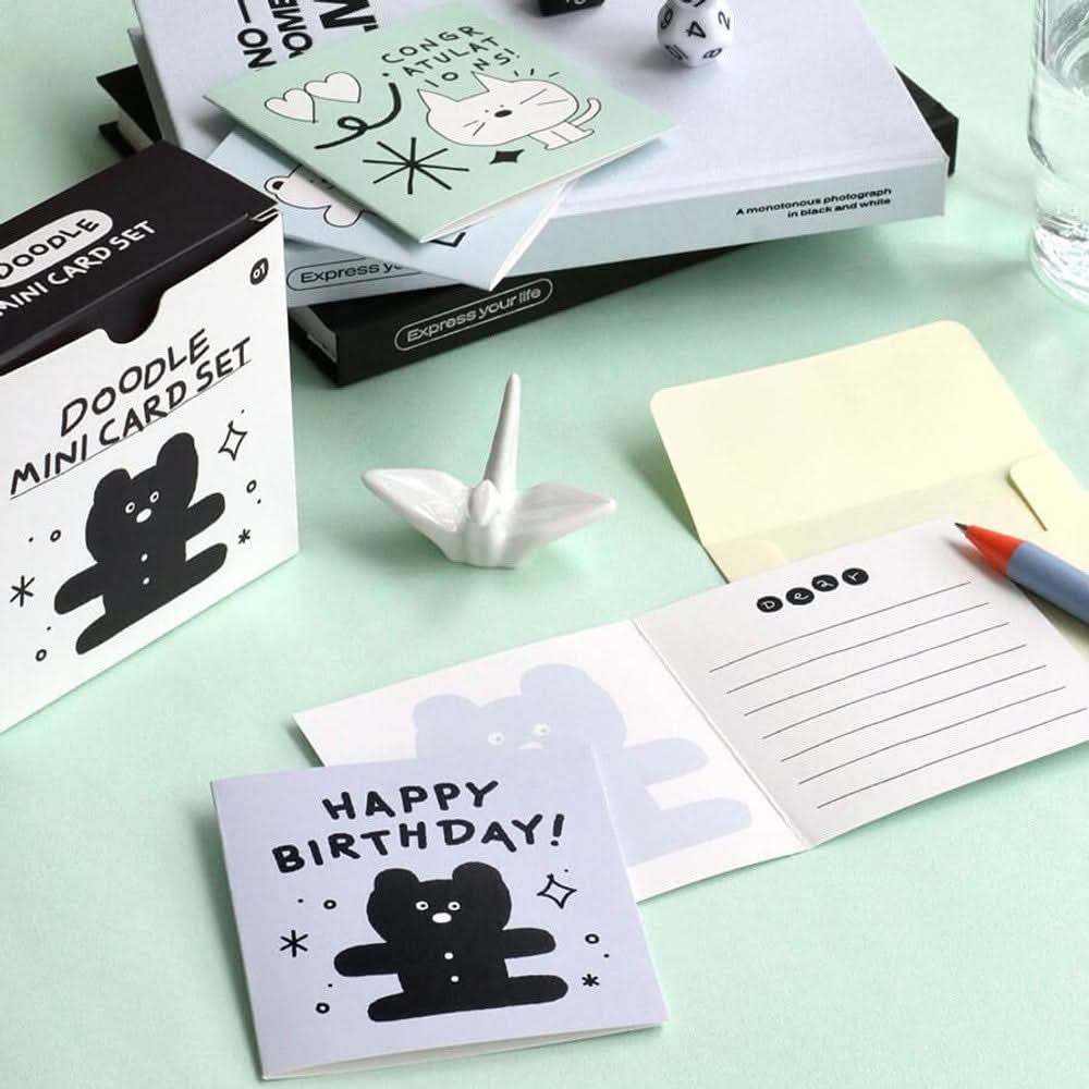 The Journal Shop - Iconic Doodle Mini Card Set black box with cute illustrated cards and envelopes arranged on pastel desk.