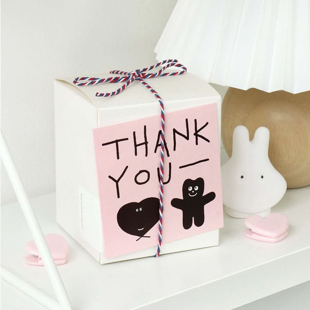 The Journal Shop - Iconic Doodle Mini Card attached to gift bag with “Thank You” message and small doodle character illustration.