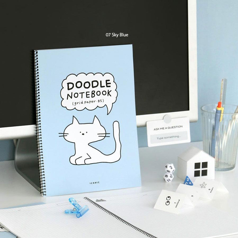 The Journal Shop - Iconic Doodle Spiral B5 Grid Notebook in blue covers shown with matching doodle-themed stationery.
