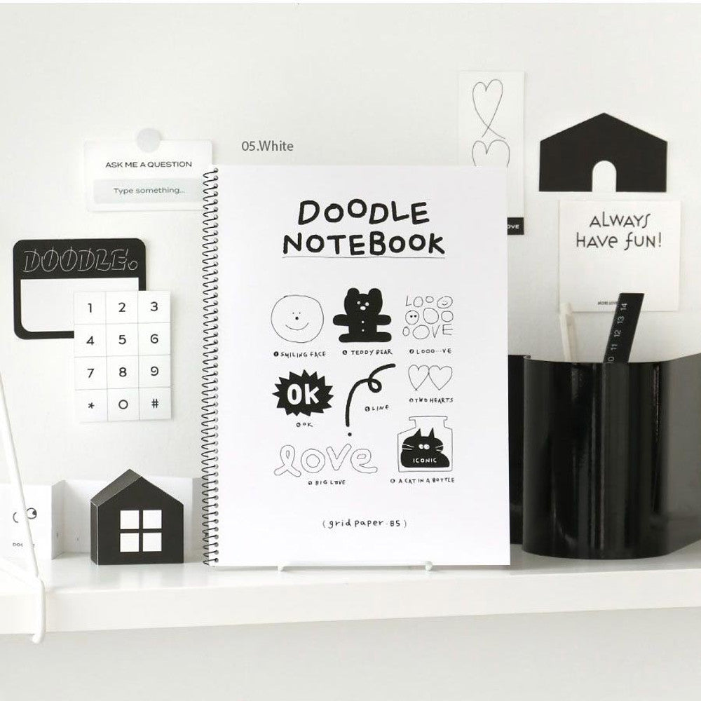 The Journal Shop - Iconic Doodle Spiral B5 Grid Notebook in white cover displayed on desk with stationery and ruler.