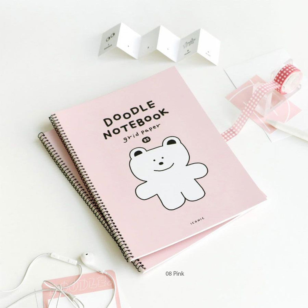 The Journal Shop - Iconic Doodle Spiral B5 Grid Notebook pink cover version displayed with ribbon and decorative accessories.