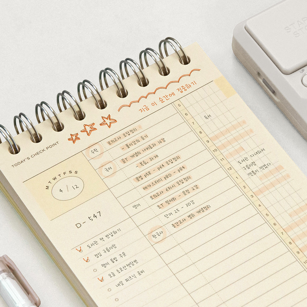 The Journal Shop - Iconic Flow B6 Spiral Study Planner open showing neatly organised daily timetable and notes layout.