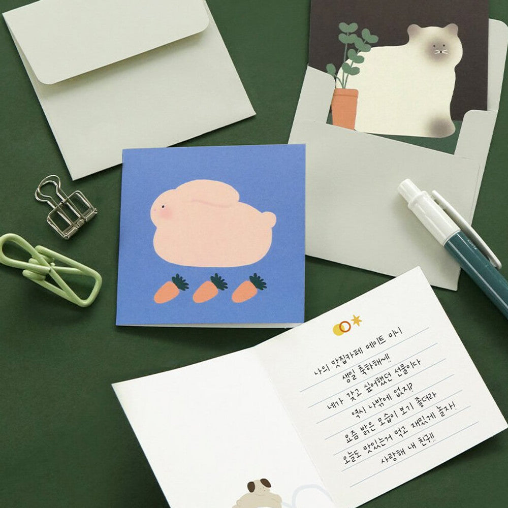 The Journal Shop - Iconic Happy Mini Card featuring cute animals design shown with matching envelope and writing accessories.