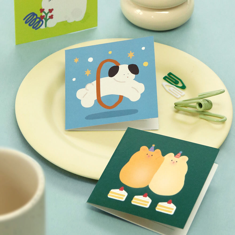The Journal Shop - Iconic Happy Mini Cards with assorted designs arranged on plate with tea and stationery accessories.