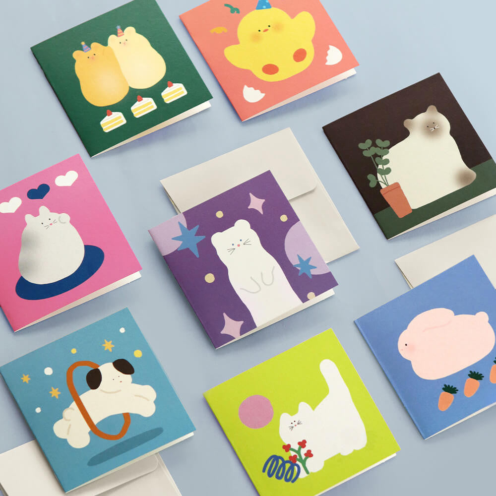 The Journal Shop - Iconic Happy Mini Cards and envelopes with playful animal prints displayed on light blue surface.