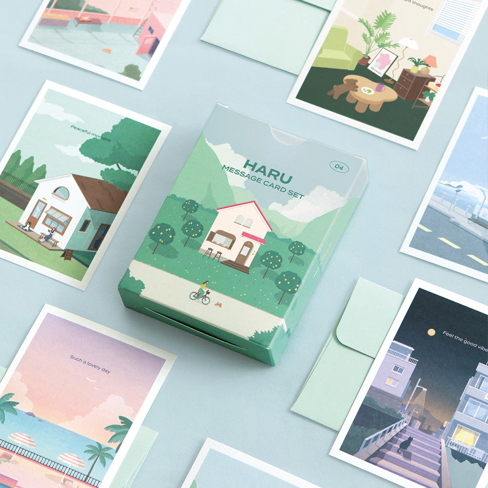 The Journal Shop - Iconic Haru Message Card Set with box, envelopes, and illustrated cards arranged aesthetically on pale blue background.