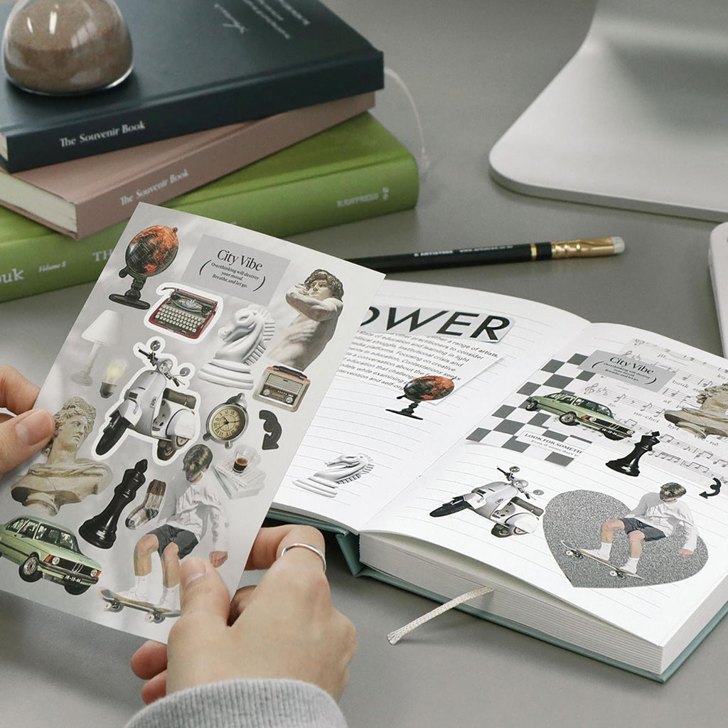 The Journal Shop - Open planner decorated with Iconic Just Object Stickers and stationery items beside it.