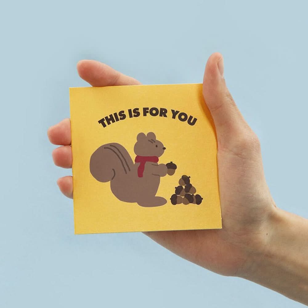 The Journal Shop - Person holding Iconic Mini Friends Card with brown squirrel illustration and “This is for you” text.