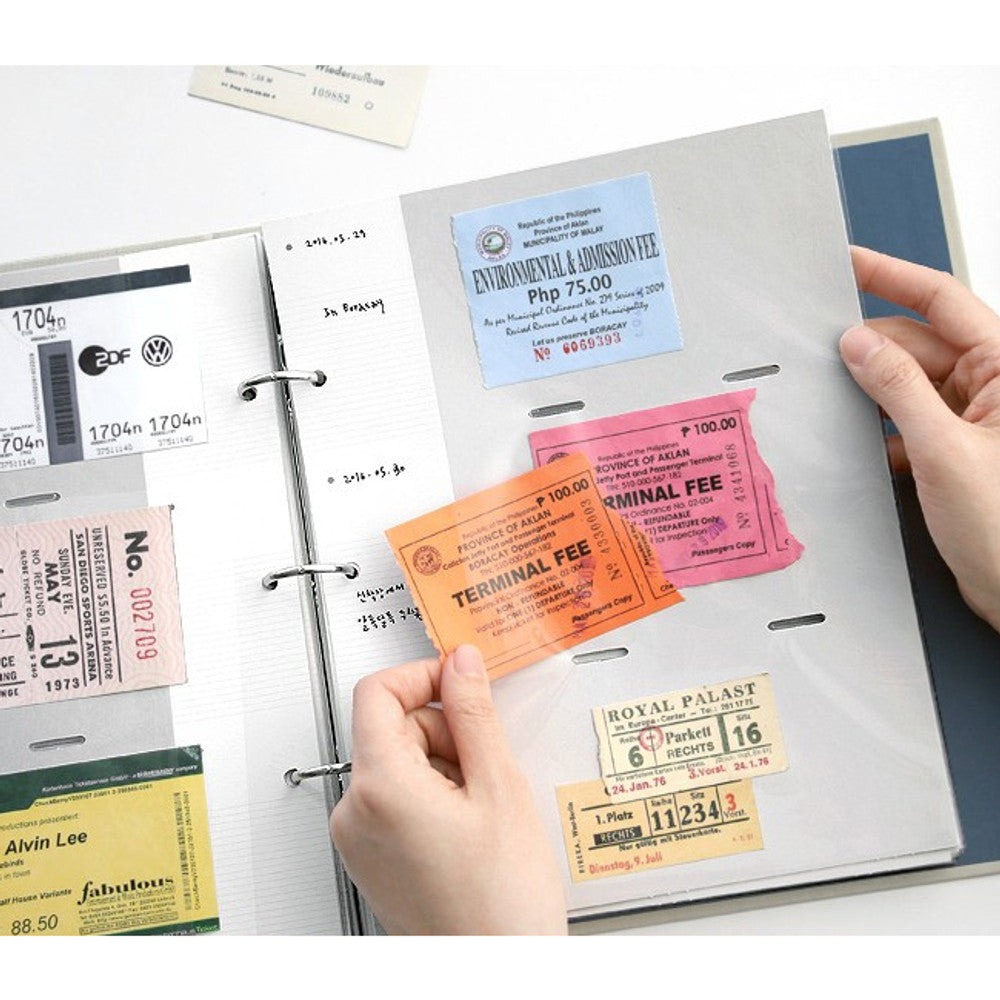 The Journal Shop - Person adding pastel tickets to the inside of a memory binder page.