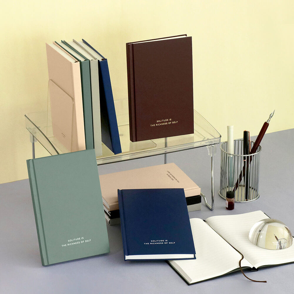 The Journal Shop - Iconic Solitude Tomoe River Line Notebooks in assorted colours displayed on desk with stationery.