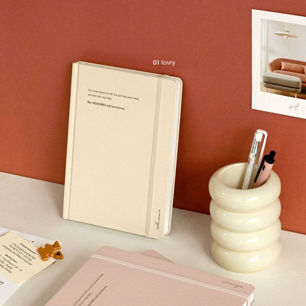 The Journal Shop - Iconic Souvenir B6 Band Notebook pink and beige hardcover journals stacked on desk with accessories.