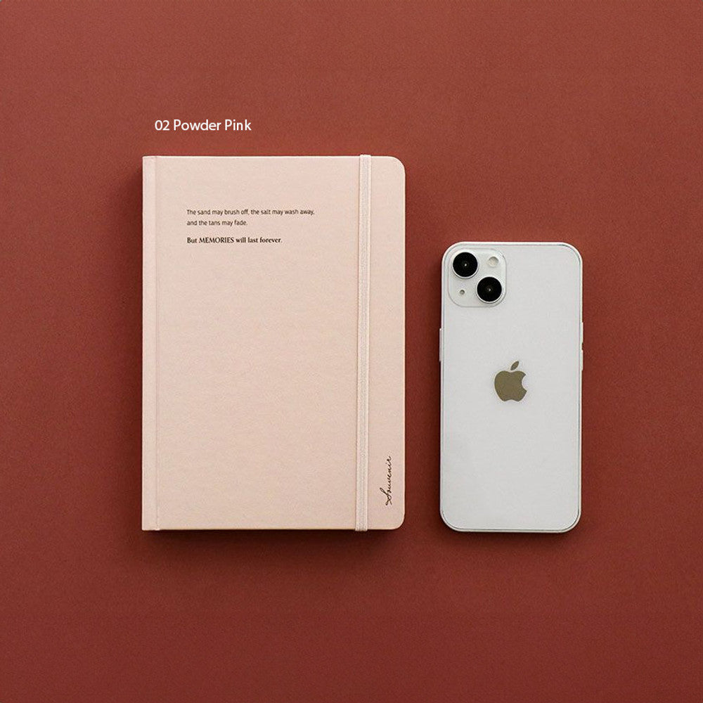 The Journal Shop - Iconic Souvenir B6 Band Notebook pink hardcover journal shown on desk beside phone.