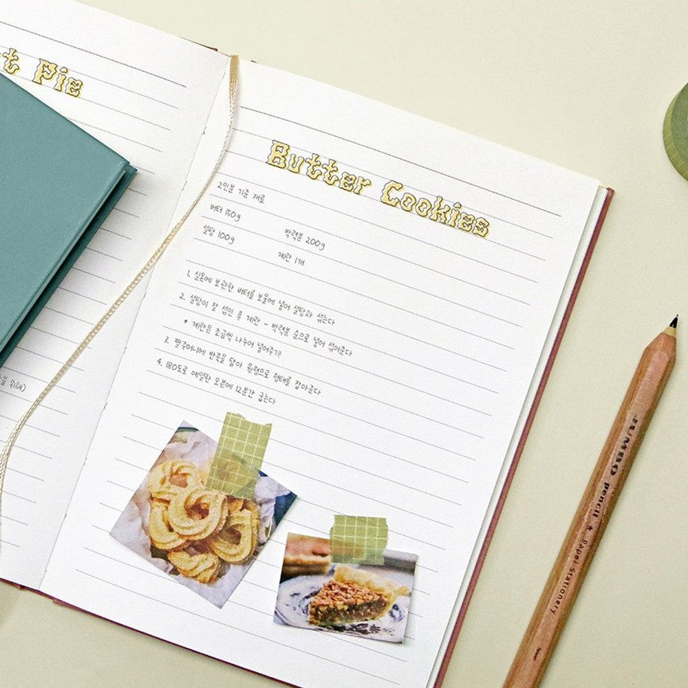 The Journal Shop - Open Iconic Souvenir notebook displaying neatly ruled pages with notes and images.