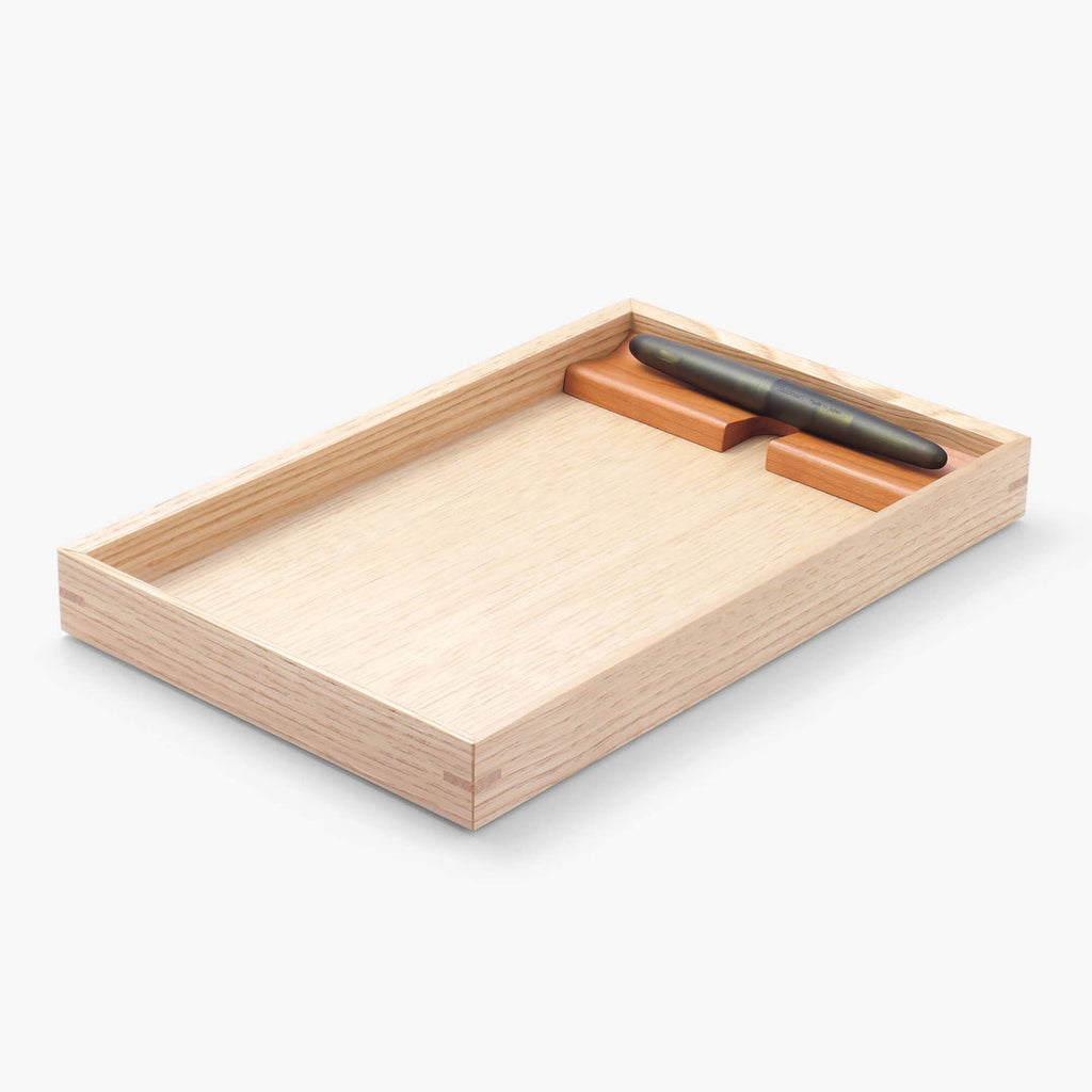 The Journal Shop - Angled image of the tray holding a pen and notepad neatly within its wooden frame.