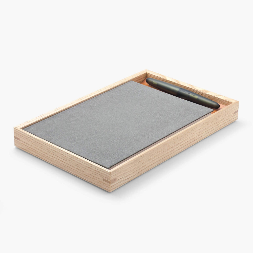 The Journal Shop - Kakimori A5 Wooden Writing Tray with a grey writing pad placed inside, ready for use.