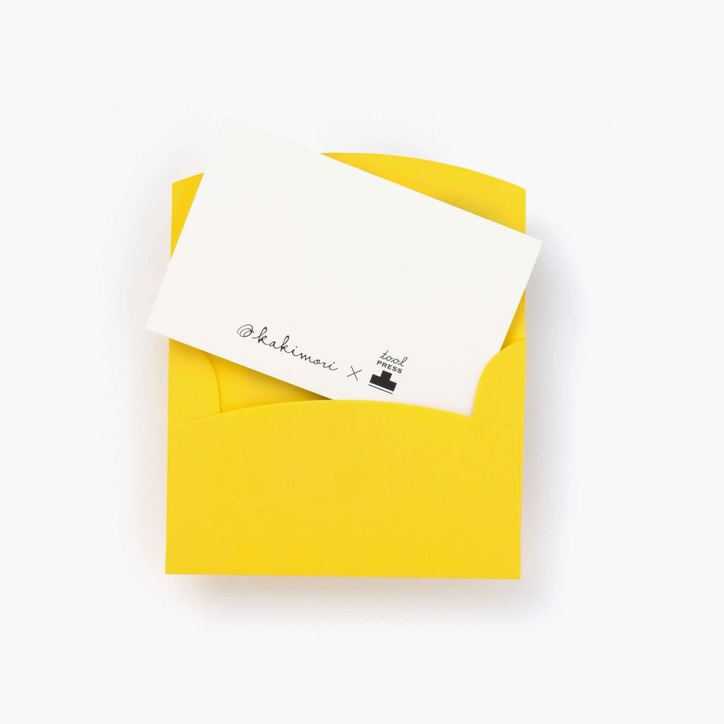 The Journal Shop - Open Kakimori Toolpress Magician card and yellow envelope showing the colourful geometric border design.
