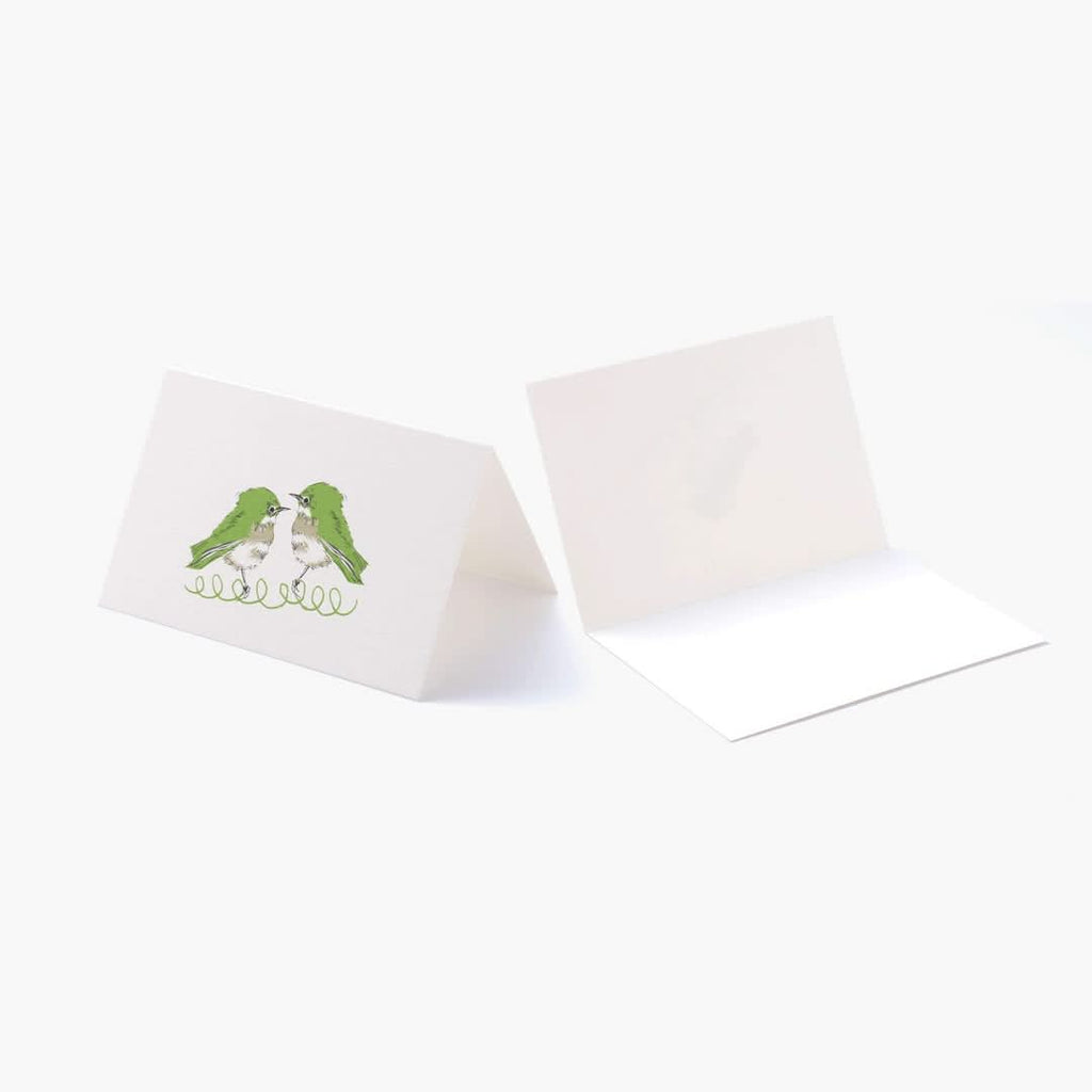 The Journal Shop - Folded Spring Bird greeting card standing open to reveal the blank interior and bird illustration.