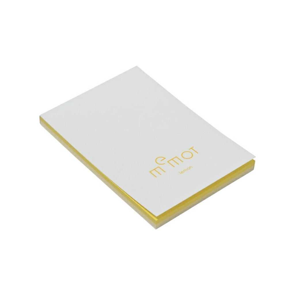 Angled view of memot notepad with yellow pages and 'lemon' label on the front.