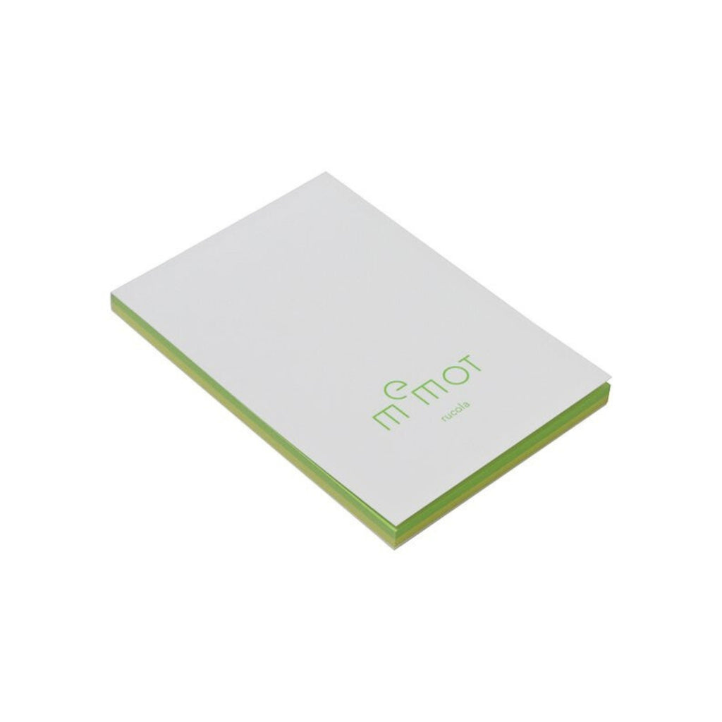 Angled view of memot notepad with green-edged pages and 'rucola' label on the cover.