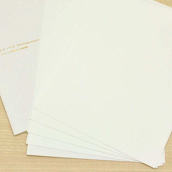 Fanned-out stack of SUITO blotting paper sheets beside the branded cover.