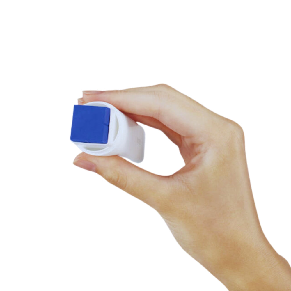Hand holding KOKUYO GLOO glue stick from the top, displaying the square blue adhesive stick.