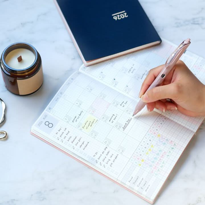 Open Kokuyo Jibun Techo Lite 2026 Mini B6 Slim Diary on desk with pen, compact and functional design.