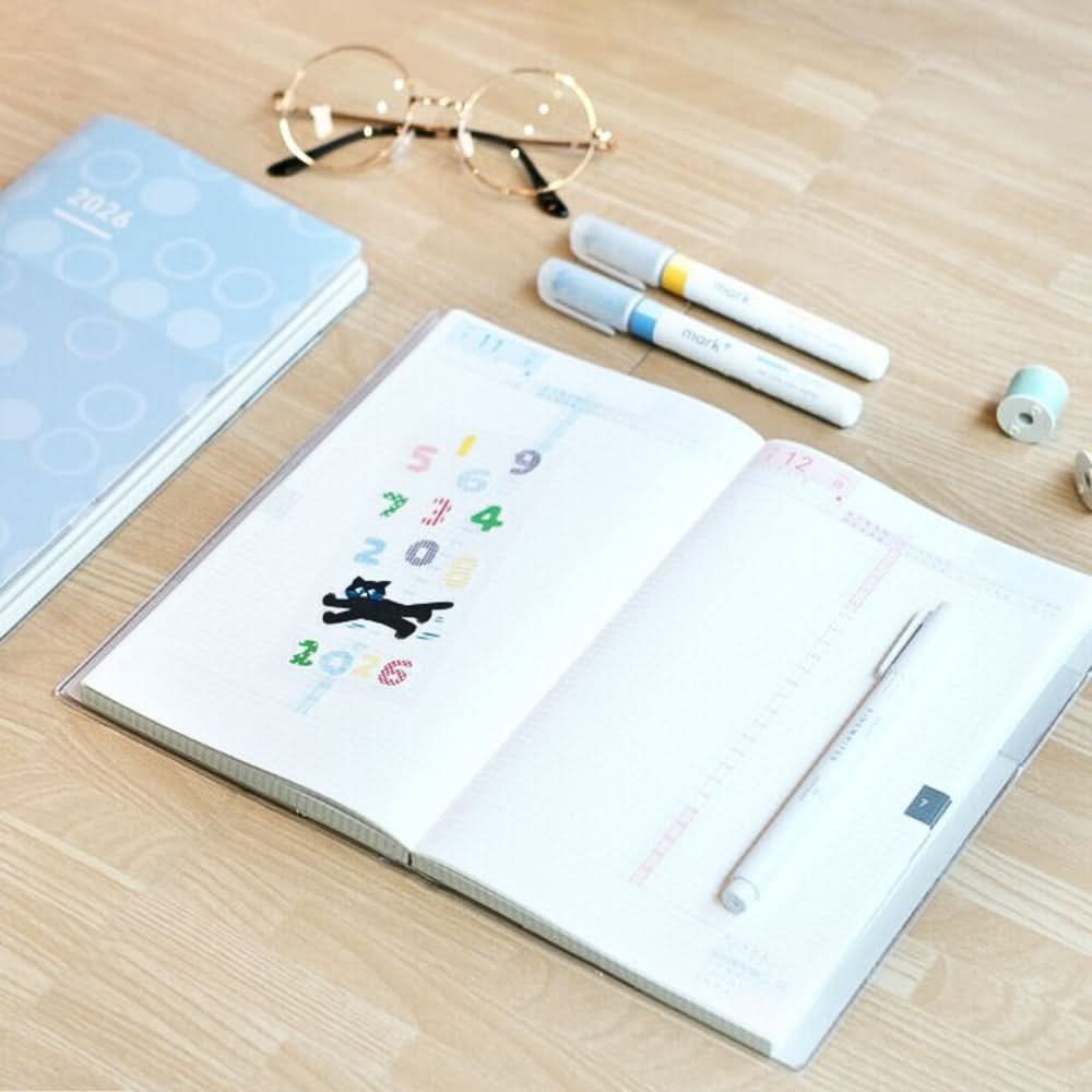 Open Kokuyo Jibun Techo DAYs 2026 A5 Slim Daily Planner SOUSOU Limited Edition on desk with stationery accessories.