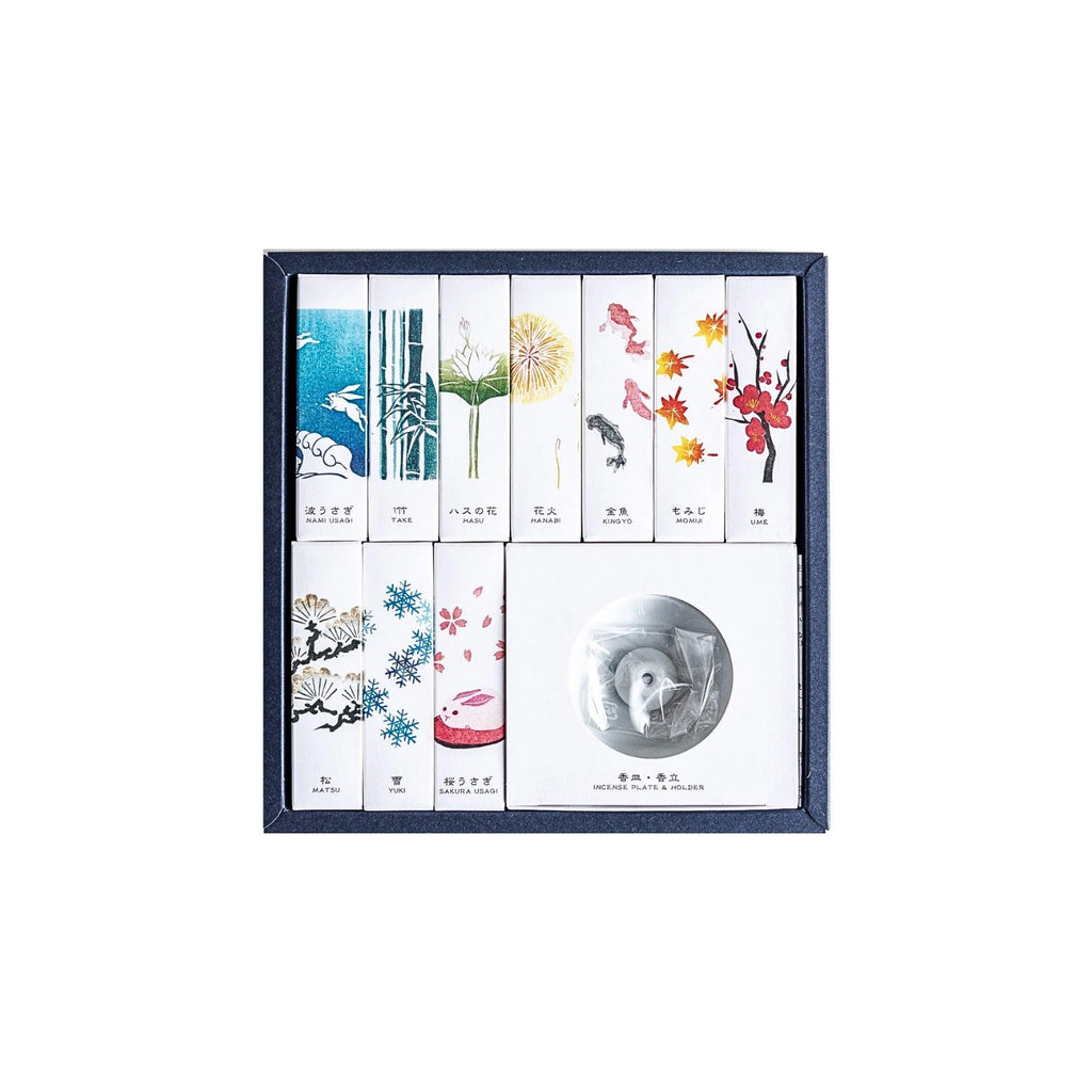Kousaido Hanga Incense Assortment box showing ten types of Japanese incense sticks arranged in a grid alongside a ceramic incense dish.