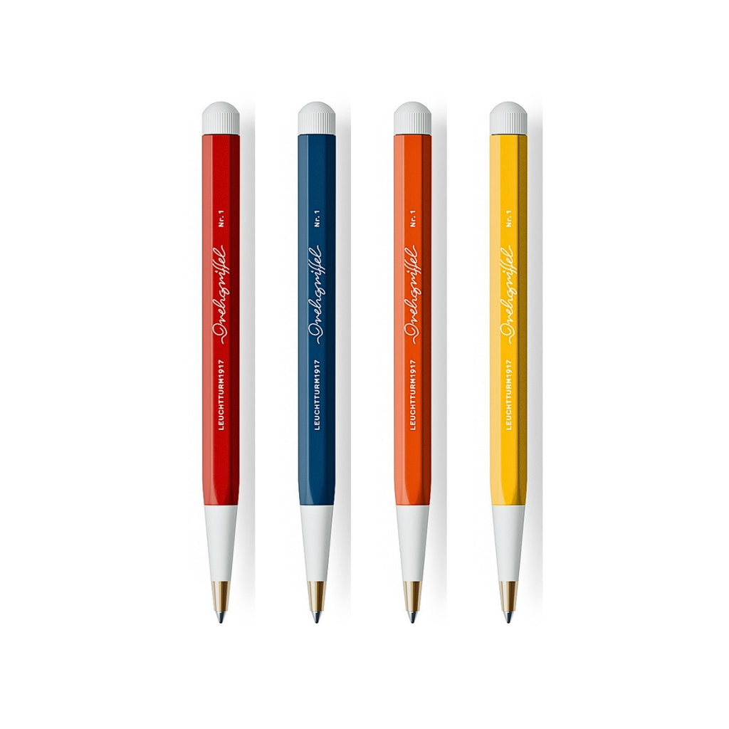 The Journal Shop - Four Leuchtturm1917 Drehgriffel Nr. 1 Ballpoint Pens in red, blue, orange, and yellow with white twist tops and tips.