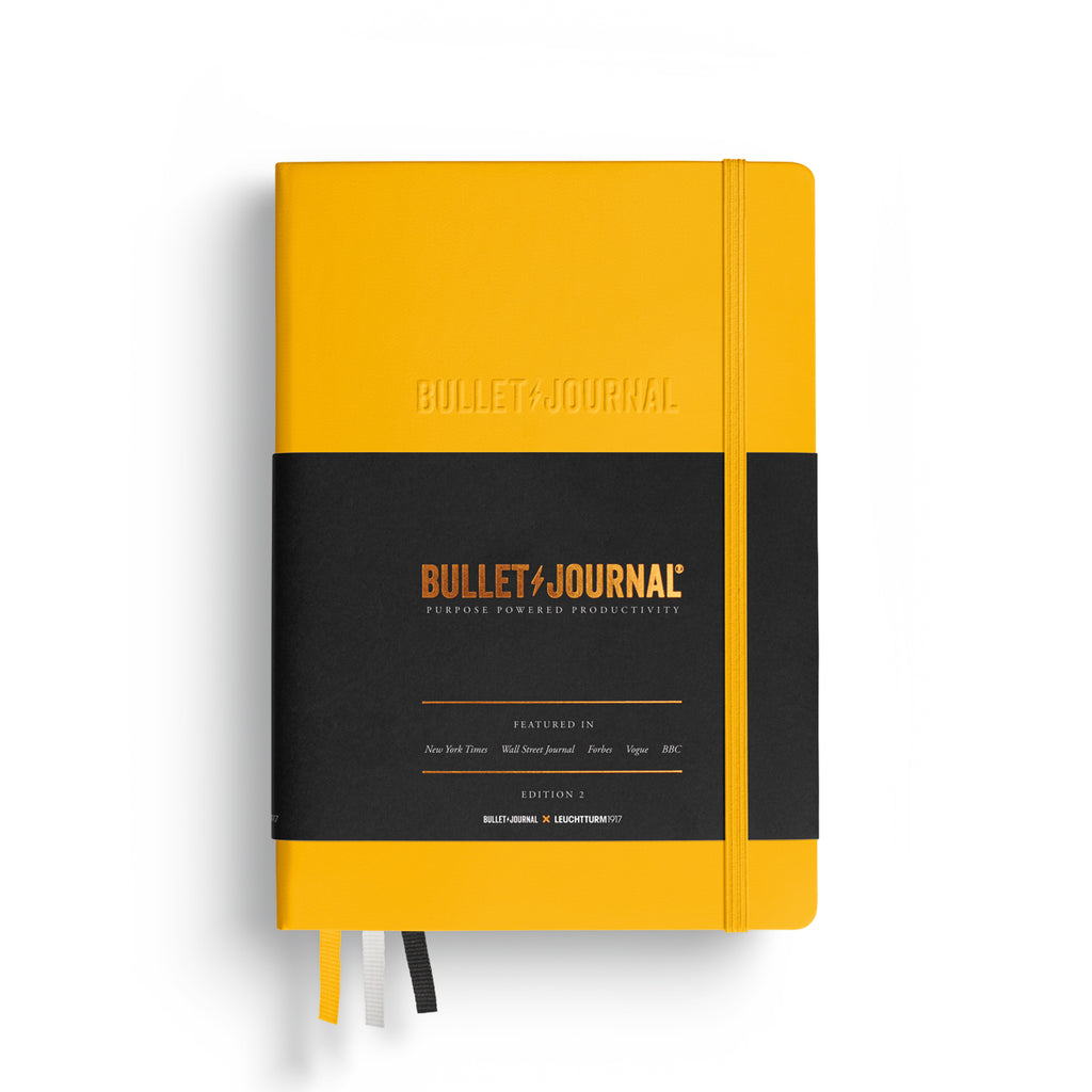 Leuchtturm1917 Bullet Journal Edition 2 notebook in mustard yellow with front cover and band visible.