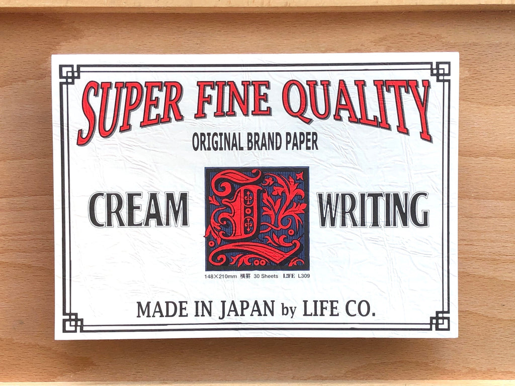 The Journal Shop - Life L-Brand Cream Ruled Writing Pad A5 with vintage-style cover design featuring red and black typography.