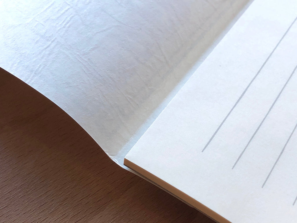 The Journal Shop - Life L-Brand Cream Ruled Writing Pad A5 corner view showing high-quality Japanese paper texture.