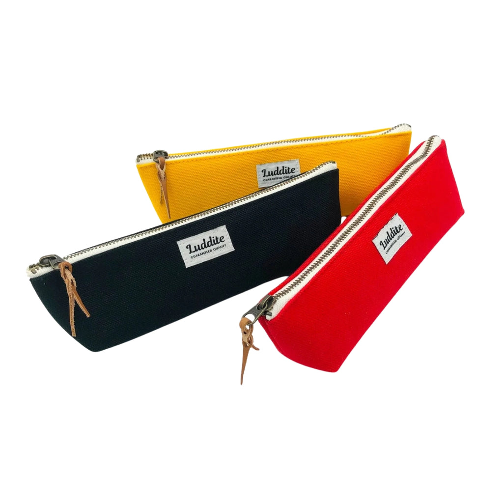 Set of three Luddite pencil cases in yellow, black, and red canvas with zip closures