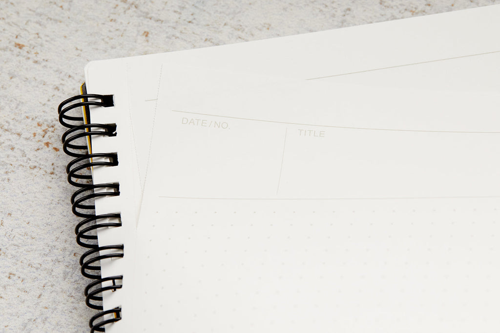 Close-up of spiral binding on the Maruman Mnemosyne A4 Planner Notebook for easy page turning.