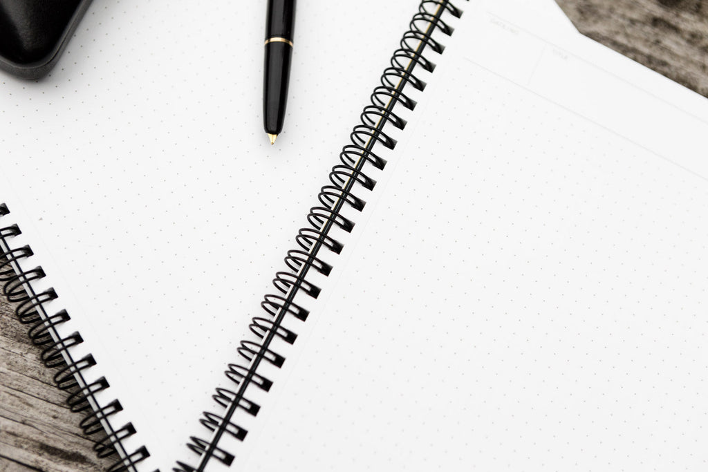 Minimal flat lay of the Maruman Mnemosyne A4 Planner Notebook on a light background.