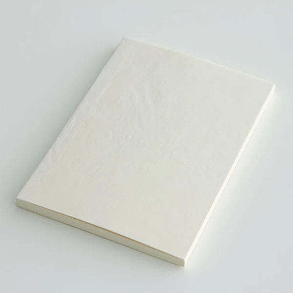 Angled view of Midori MD Paper Notebook A6 Ruled with thread-stitch binding, slim and portable.