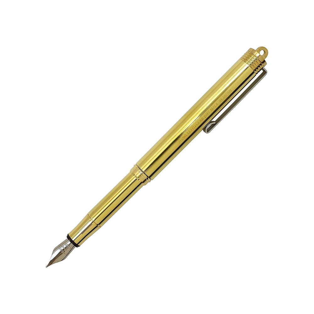 Open Midori Compact Brass Fountain Pen in gold with fine nib extended, displaying elegant writing tip.