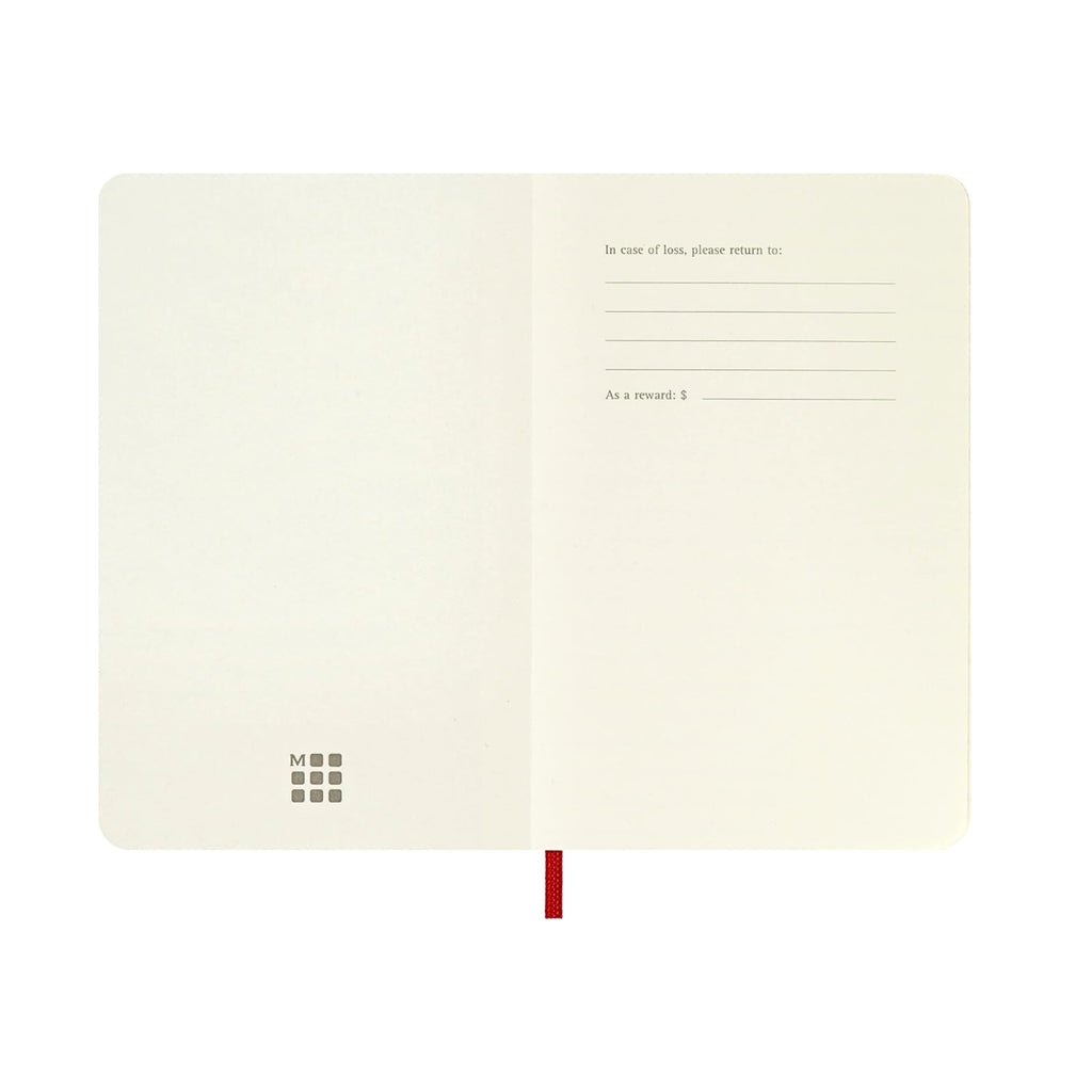 Moleskine Classic Pocket Notebook in scarlet red open flat to a blank spread.