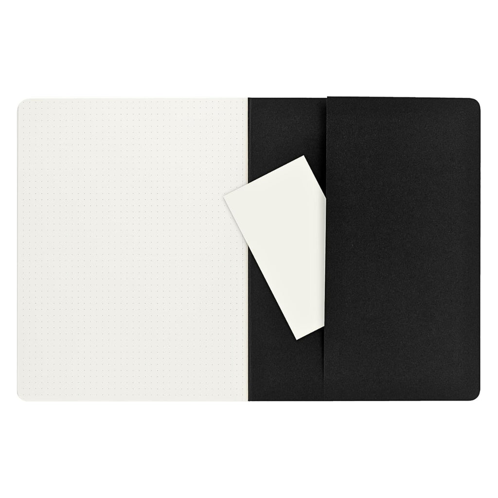 Flatlay of open Moleskine Extra Large Black Cahier showing dotted pages and black cover.