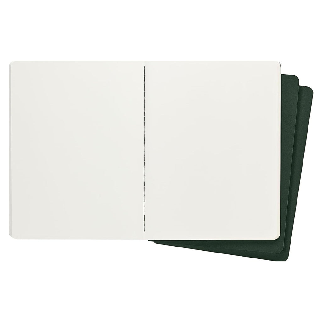 Open Moleskine Extra Large Cahier in Myrtle Green showing cream plain pages.