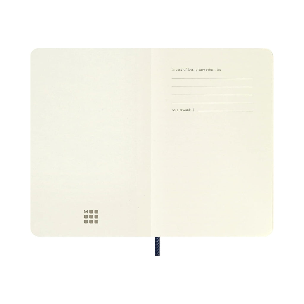 Open Moleskine Classic Pocket Soft Cover notebook showing plain ivory pages.