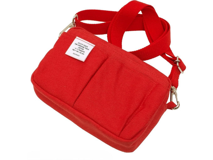 Red utility pouch laid flat with an attached adjustable shoulder strap and visible label.