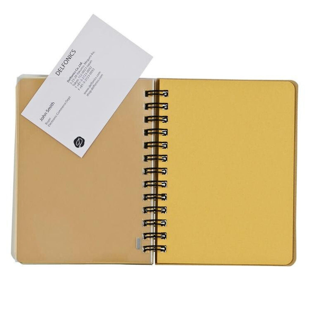 An inside view of a mini Rollbahn notebook with a yellow page and a clear plastic pocket holding a business card.
